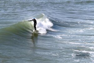 Ken Roose, Navarre Pier, 2014. Ken is wearing an AquaLid, one of the first head gear items specifically made for surfing. These sold out in the Greg Noll Surf Shop in 1969-70. Photo by Lisa Traweek.